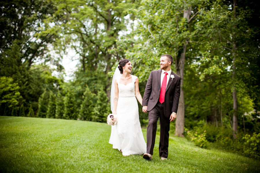 bride and groom walking on grounds of The Bradford Estate wedding budget